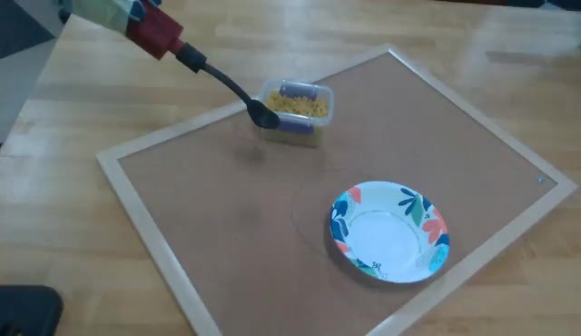Cosmos3-generated video of a robotic arm scooping pasta into a plate
